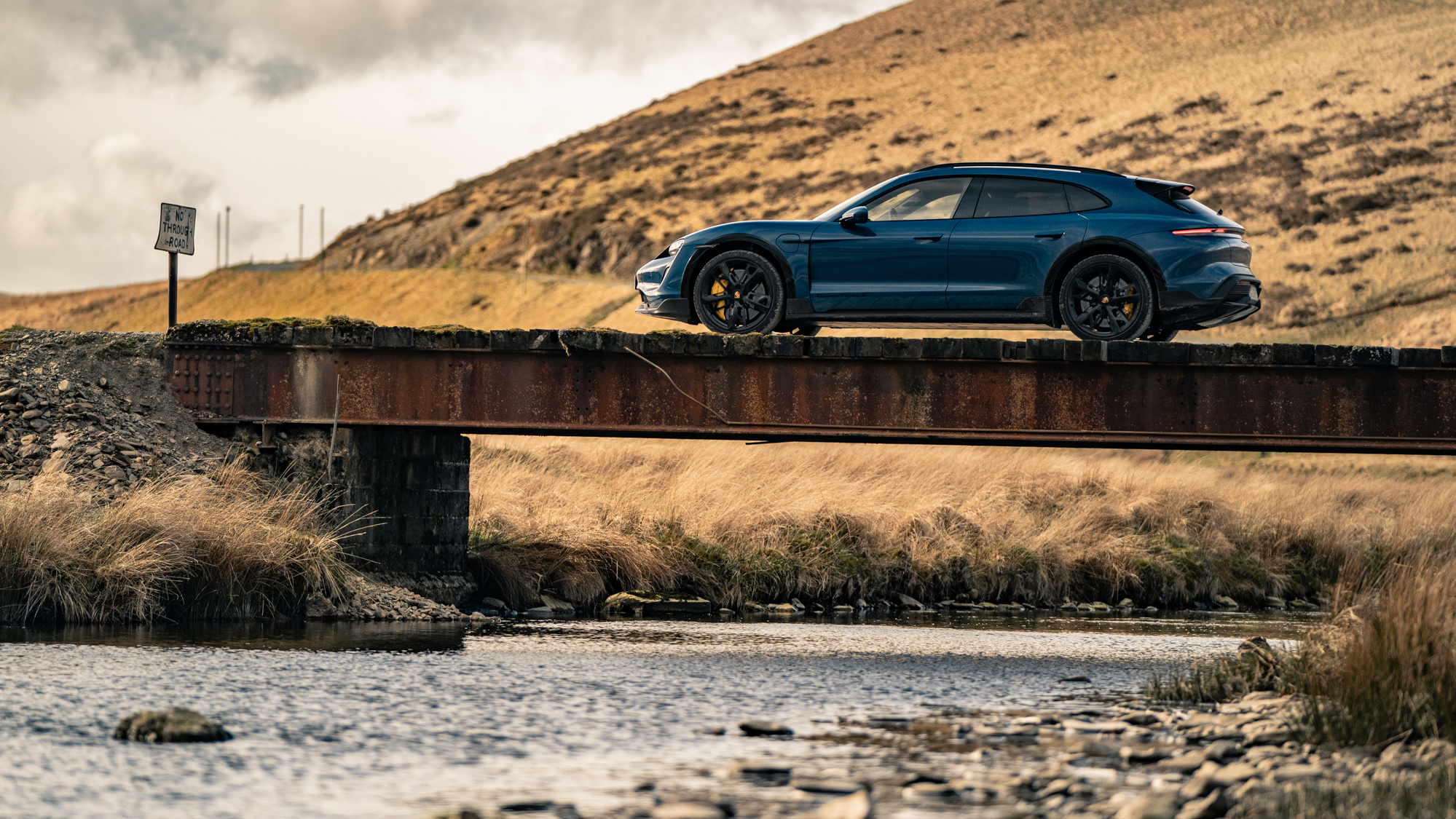 image of an SUV on a bridge